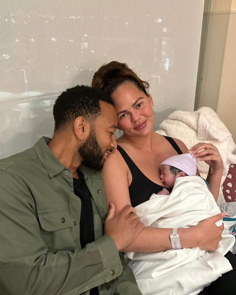 John Legend and Chrissy Teigen holding their son Wren.