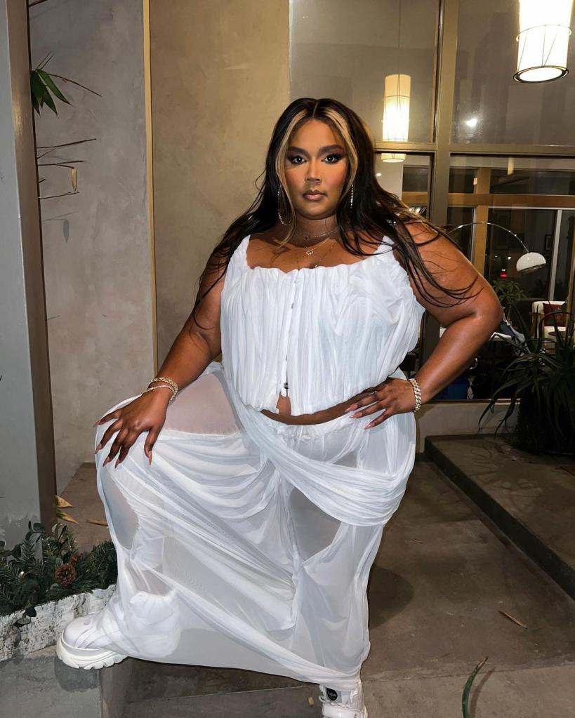 Lizzo wearing a wet-looking white dress