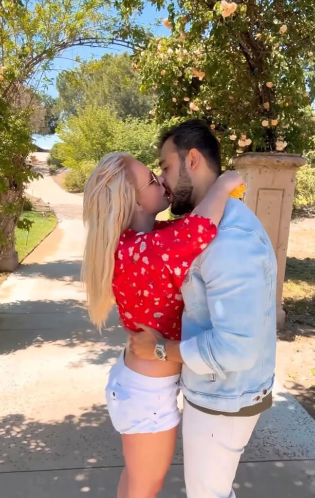 Sam Asghari and Britney Spears kissing.