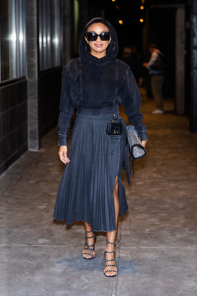 Jeannie Mai walking in alone in black.