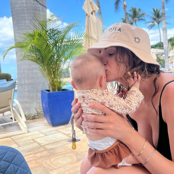 "Ginna & Georgia" star Brianne Howey kisses her baby.