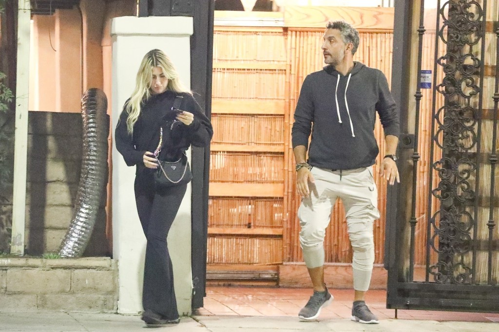 Mauricio Umansky and Emma Slater holding hands. 