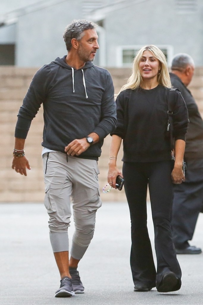 Mauricio Umansky and Emma Slater holding hands. 