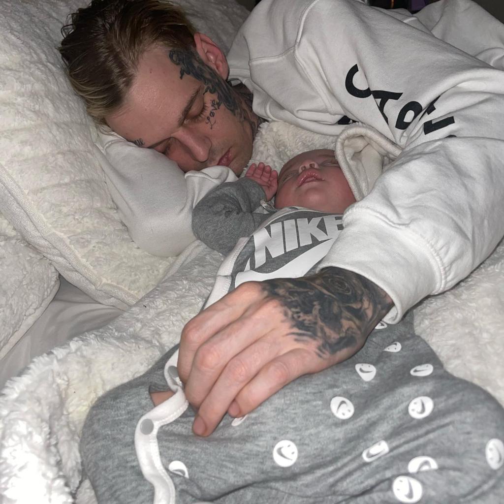 Aaron Carter in bed with his son.