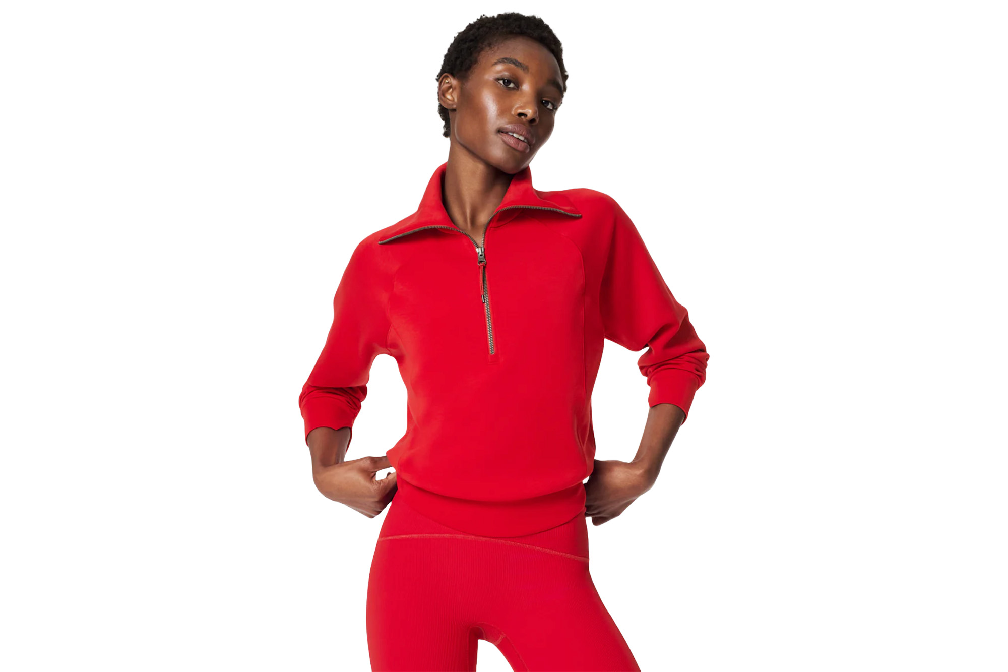 A model in a red Spanx half-zip