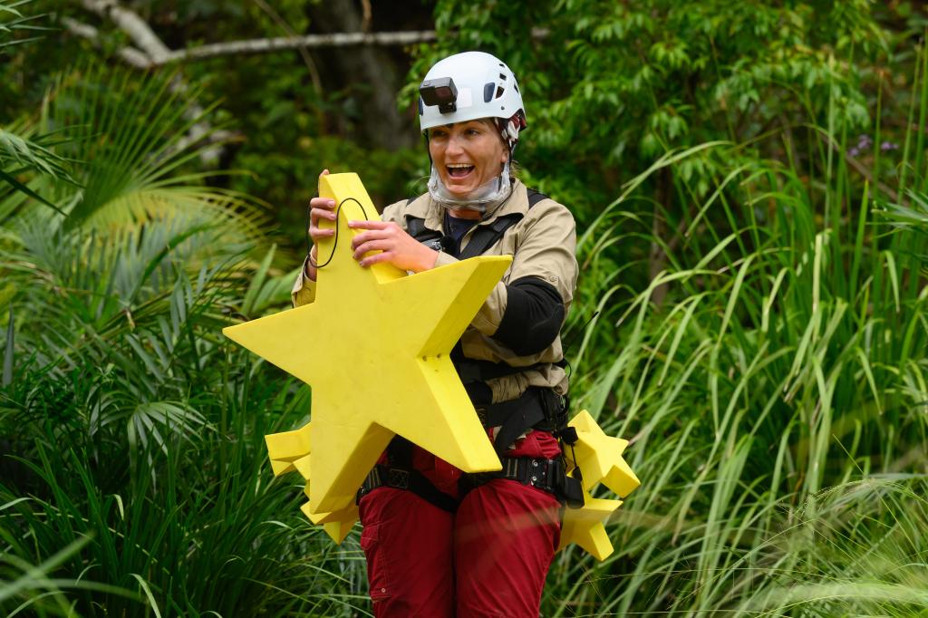 Jamie Lynn Spears in the jungle, holding a large plastic star