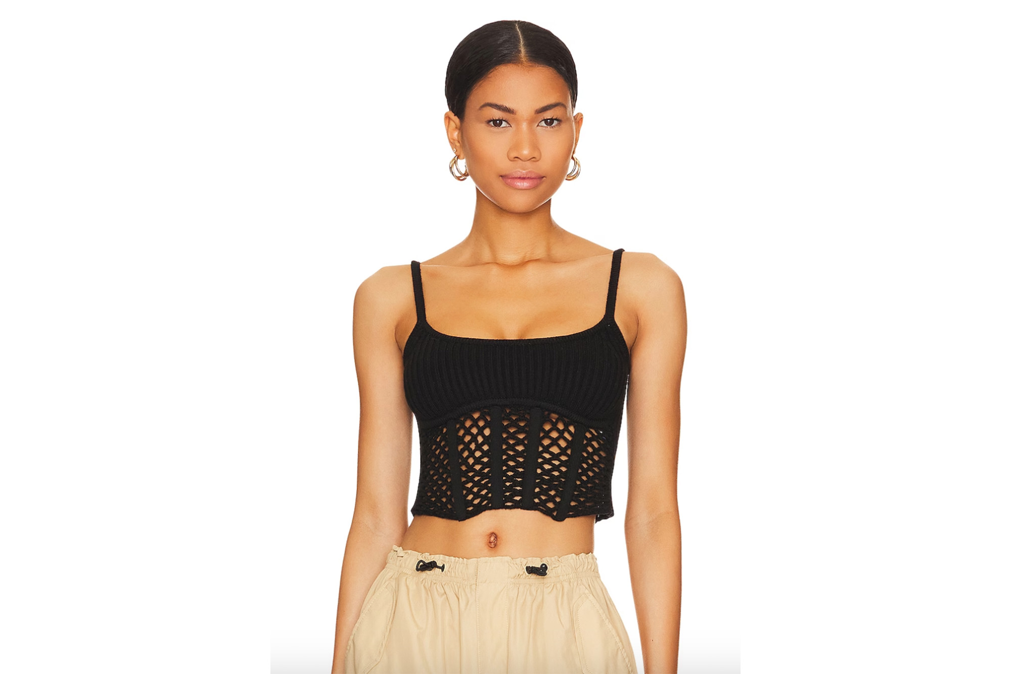 A model in a black crocheted corset top