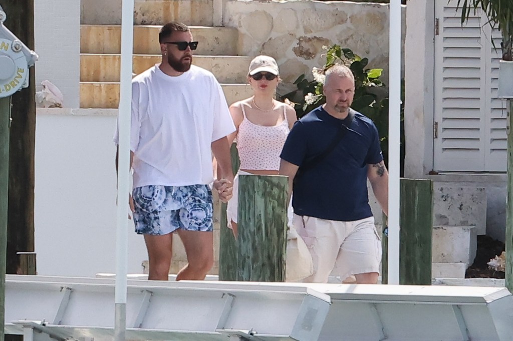 Travis Kelce and Taylor Swift holding hands in the Bahamas. 