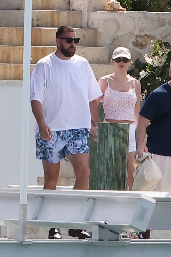 Travis Kelce and Taylor Swift holding hands in the Bahamas. 