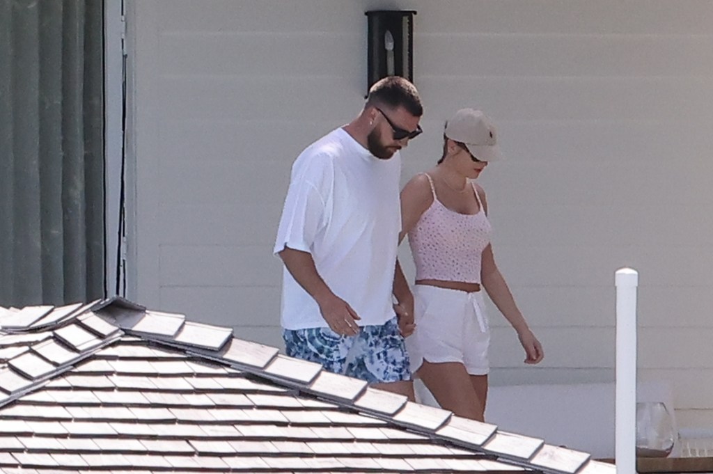 Travis Kelce and Taylor Swift holding hands in the Bahamas. 