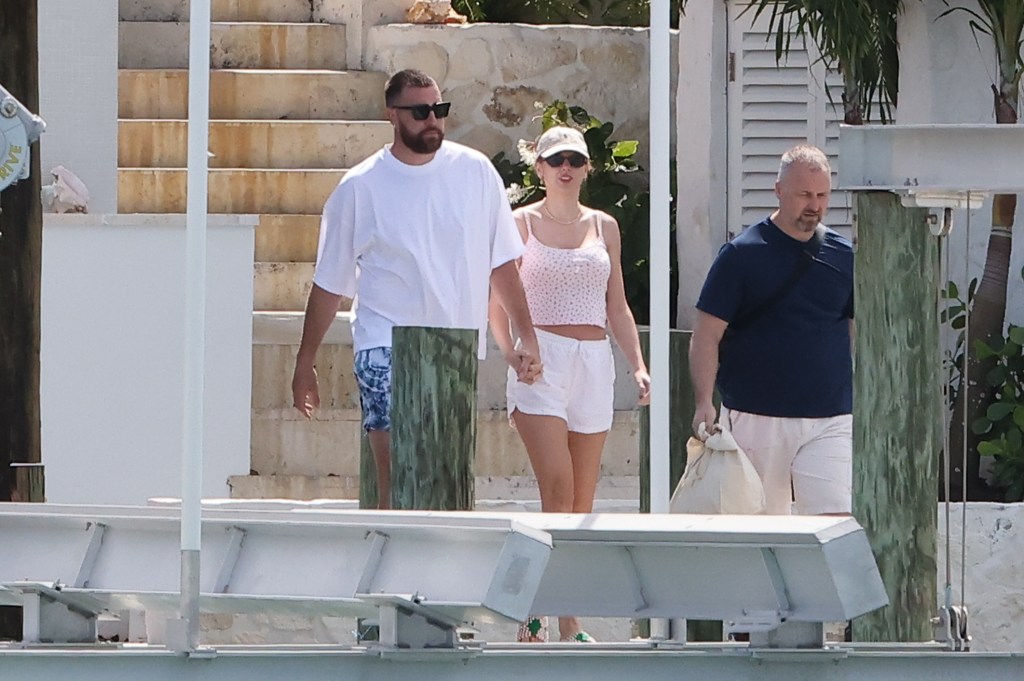 Travis Kelce and Taylor Swift holding hands in the Bahamas. 