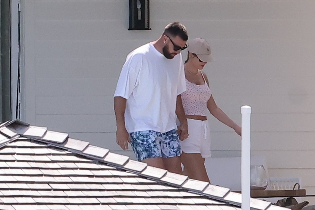 Travis Kelce and Taylor Swift holding hands in the Bahamas. 