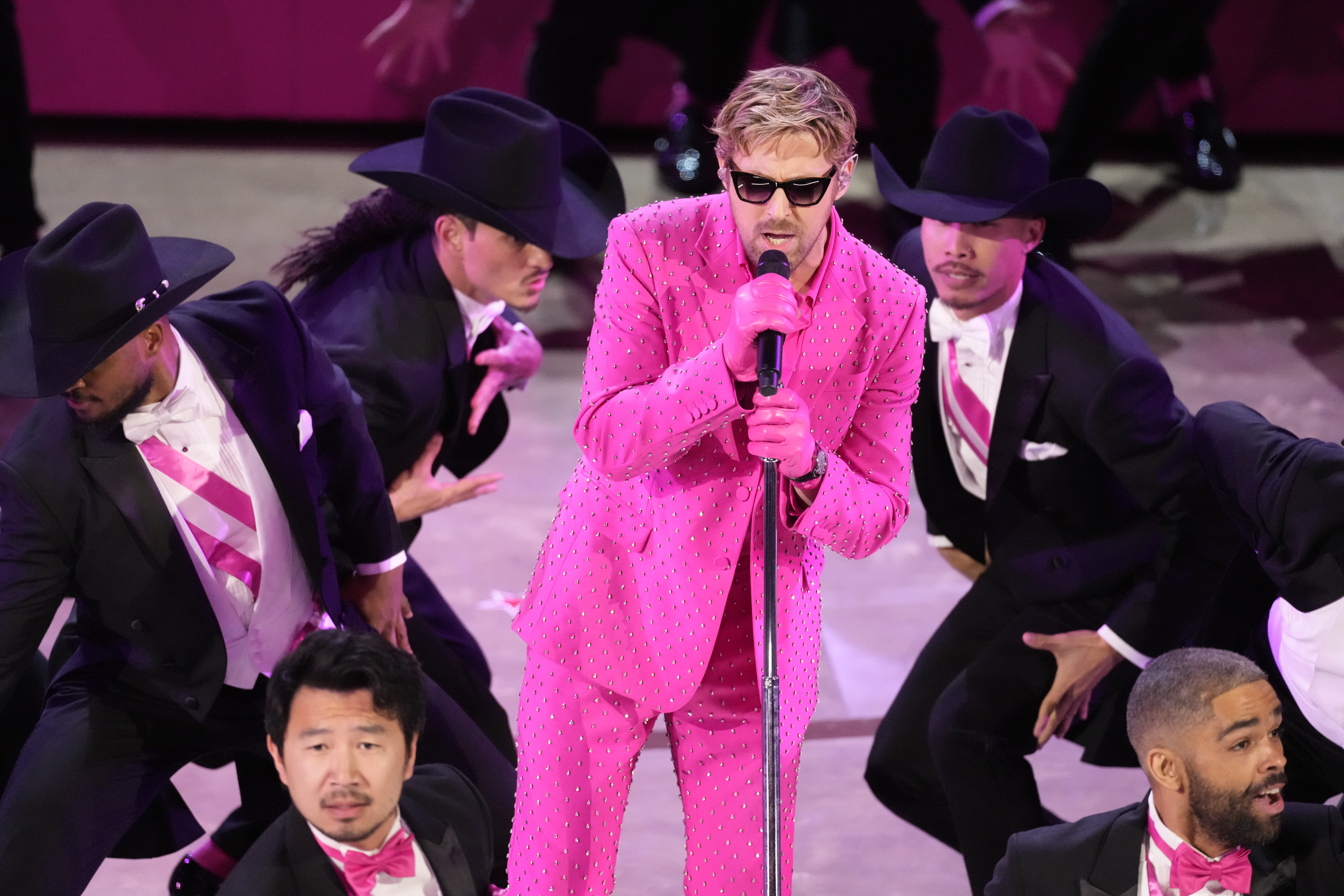 Ryan Gosling singing in a pink outfit