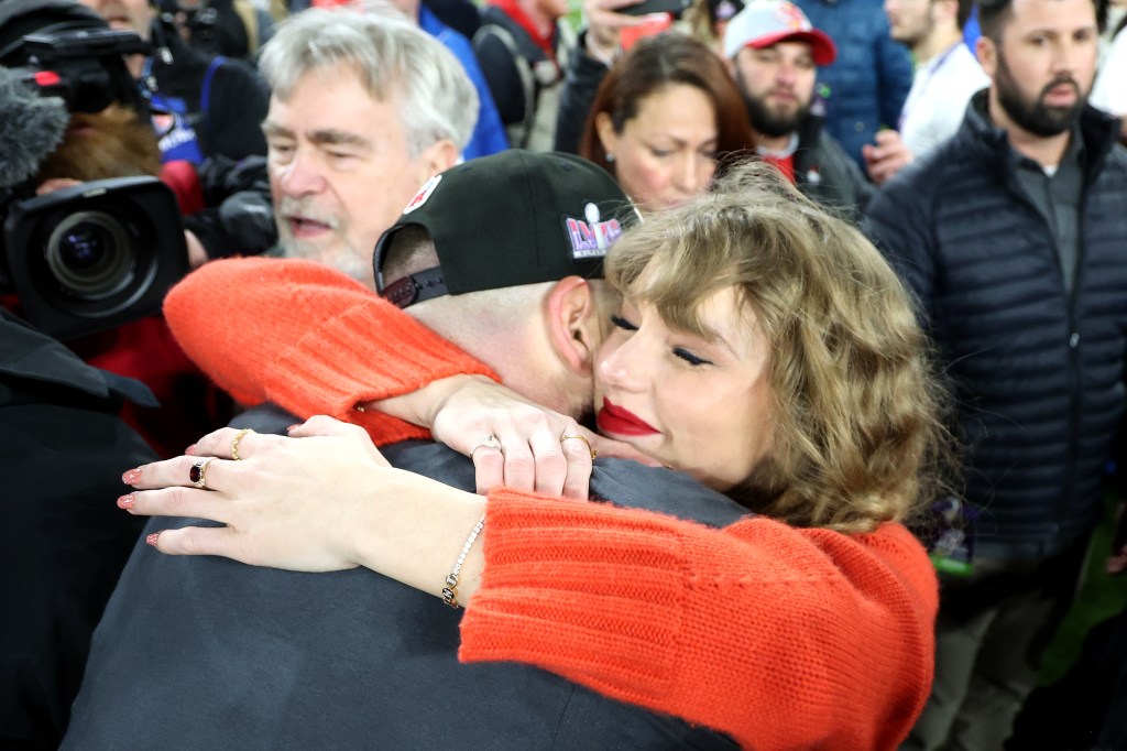 Taylor Swift and Travis Kelce on the football field. 