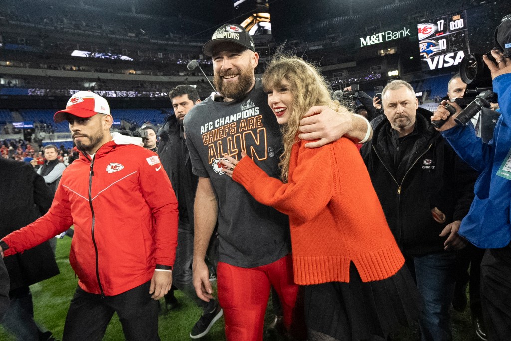 Taylor Swift and Travis Kelce on the football field. 