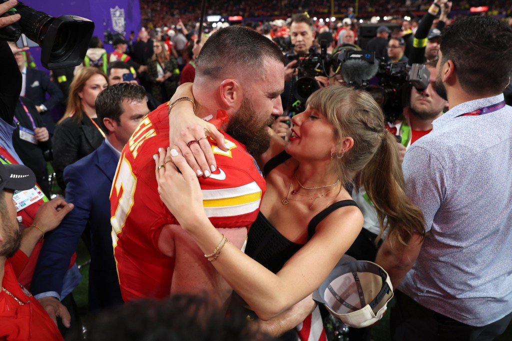 Taylor Swift and Travis Kelce on the football field. 