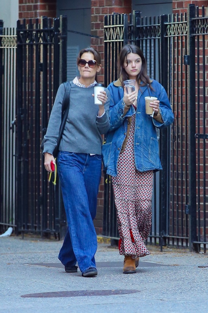 Katie Holmes and Suri Cruise walking with coffee in New York City. 