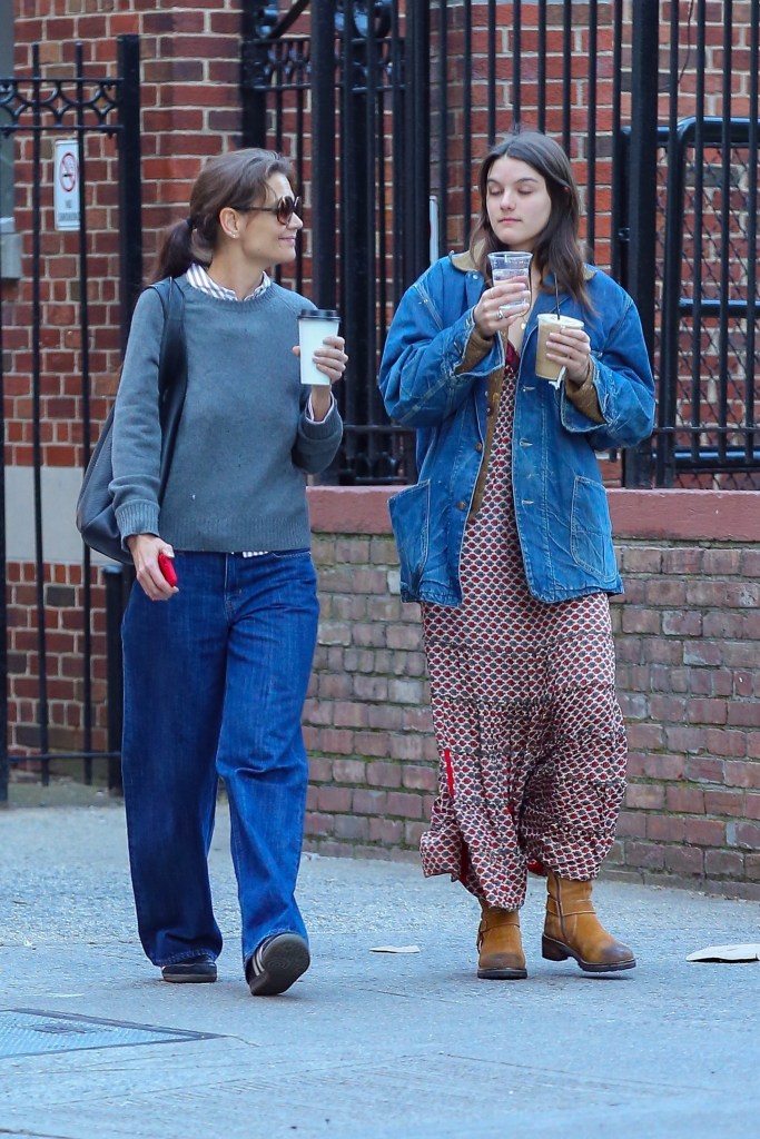 Katie Holmes and Suri Cruise walking with coffee in New York City. 