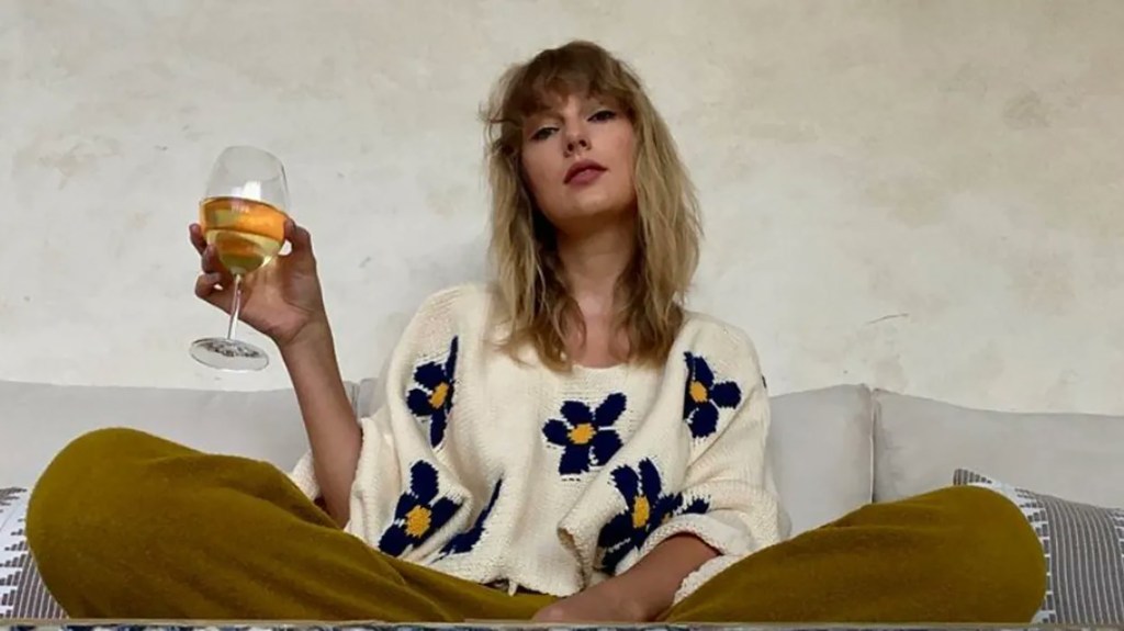 Taylor Swift drinking wine. 