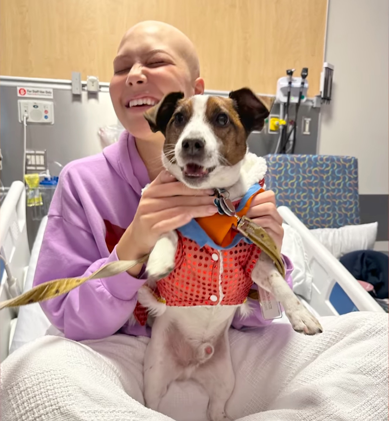 Isabella Strahan holding a dog in the hospital.