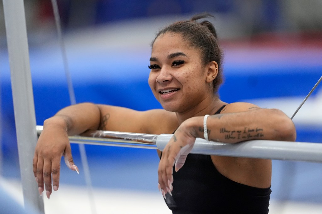 Chiles rests with her arms on the bar during a training session.