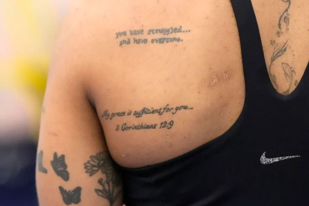 Chiles has two quotes tattooed on her back that can be seen through her sports bra.