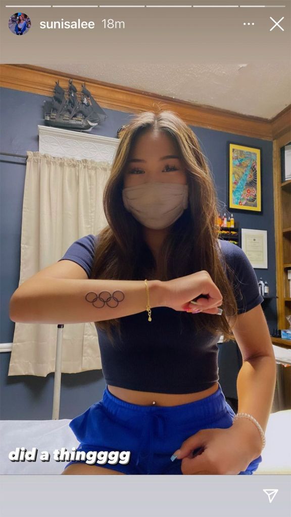 Suni Lee shows off her Olympic rings tattoo in an Instagram story.