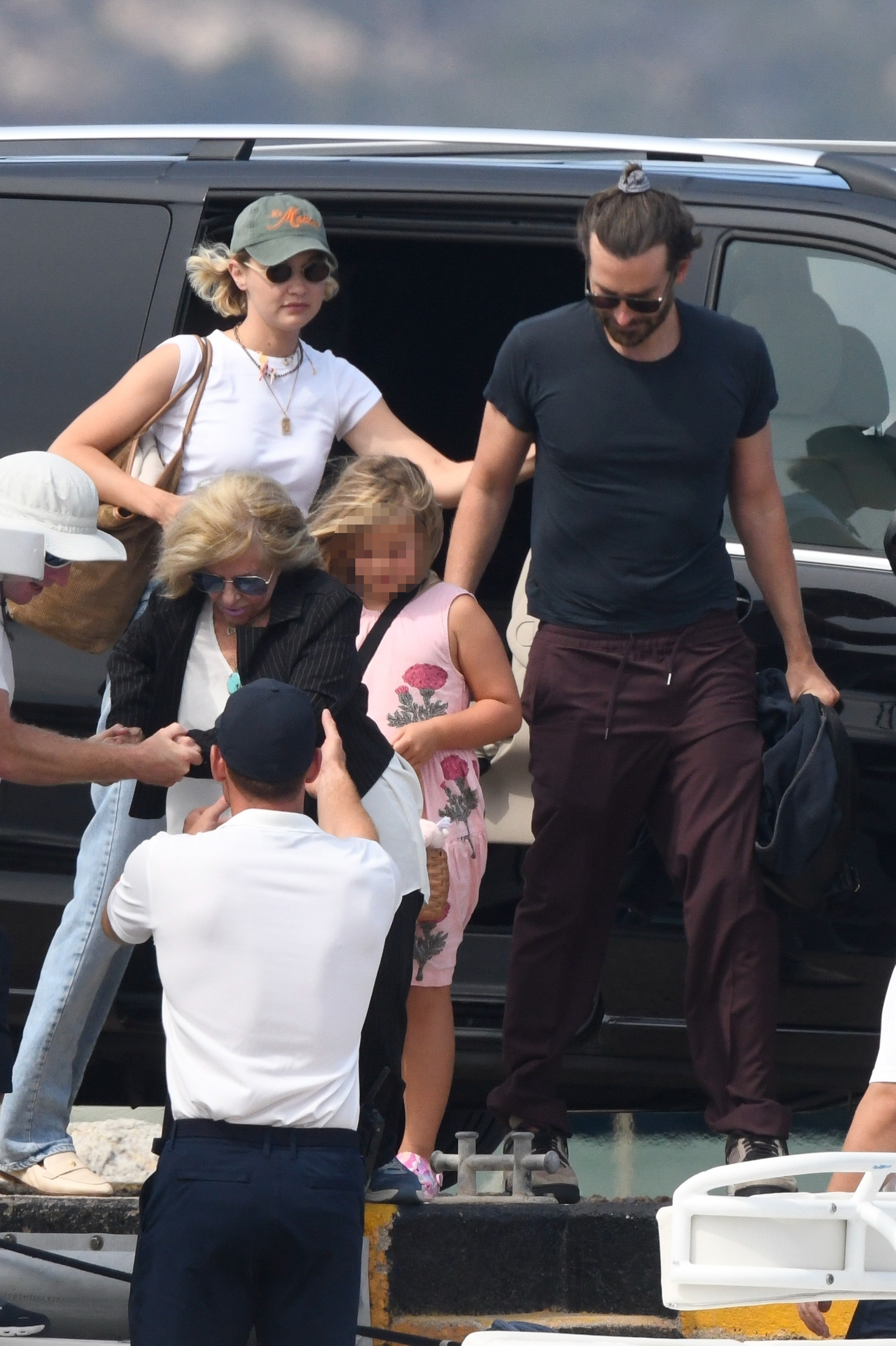 Gigi Hadid and Bradley Cooper getting out of a car with his daughter