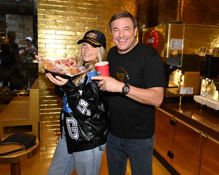 Cheers to 28 years! “Sports Illustrated” model Camille Kostek celebrates Raising Cane’s “golden birthday” with owner and founder Todd Graves at the grand opening event of Raising Cane’s one-of-a-kind golden restaurant in downtown Boston.