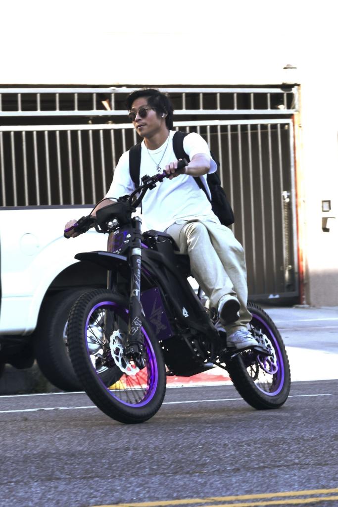 pax jolie-pitt rides his e-bike without a helmet