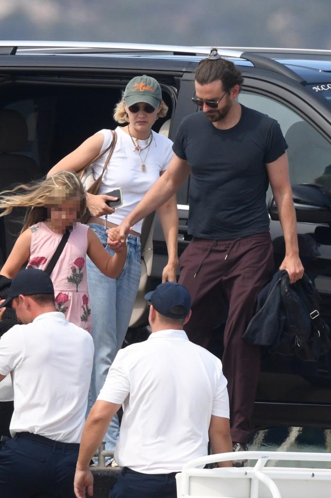 Gigi Hadid and Bradley Cooper getting out of a car with his daughter