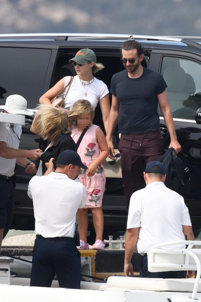 Gigi Hadid and Bradley Cooper getting out of a car with his daughter