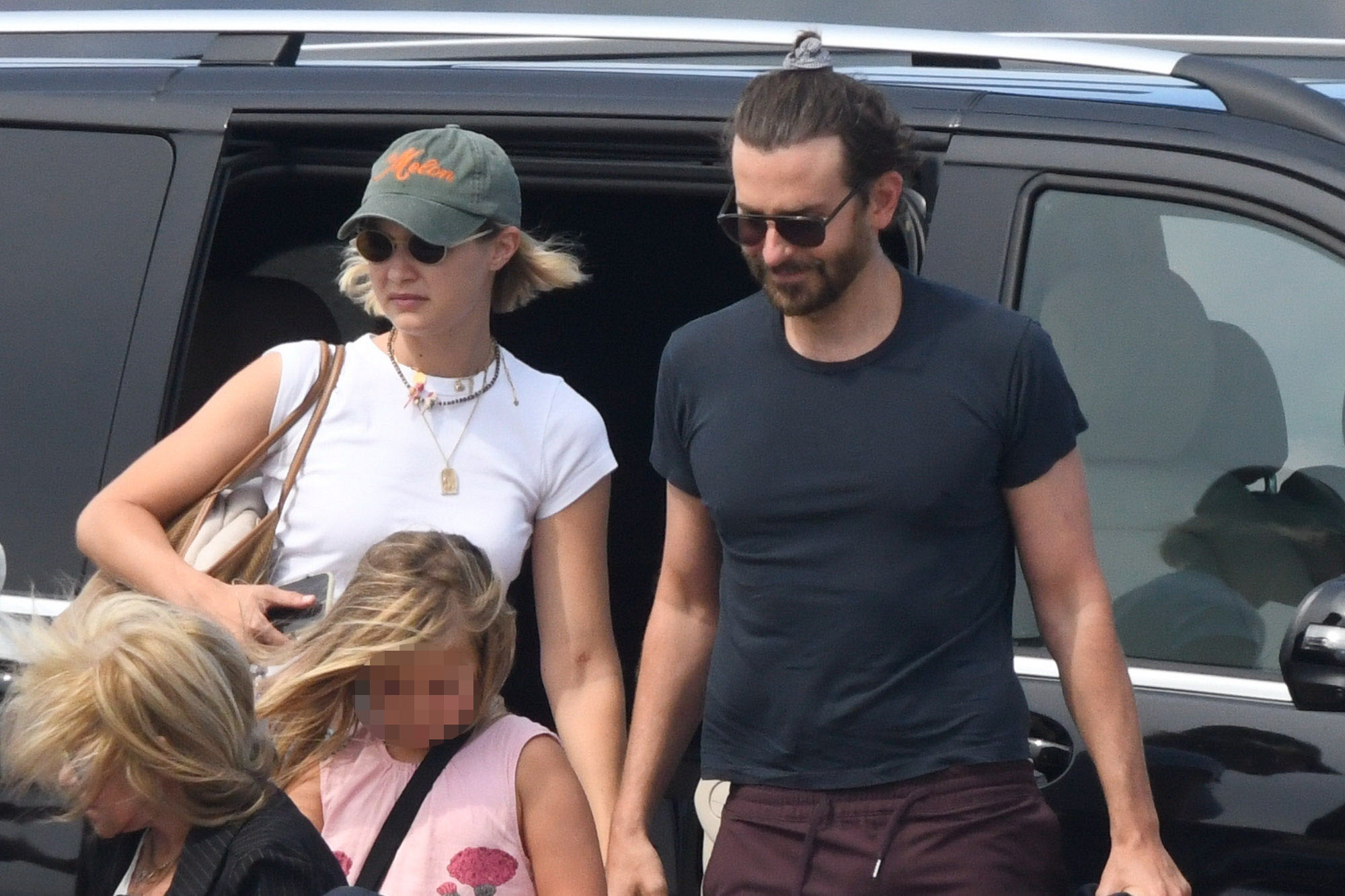 Gigi Hadid and Bradley Cooper getting out of a car with his daughter