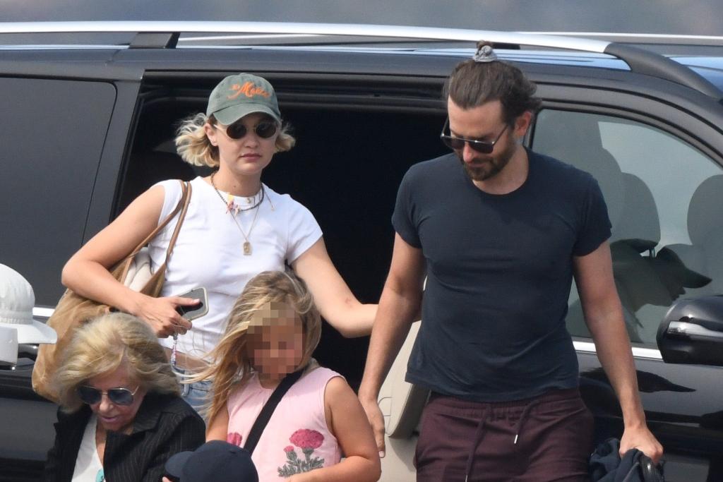 Gigi Hadid and Bradley Cooper getting out of a car with his daughter