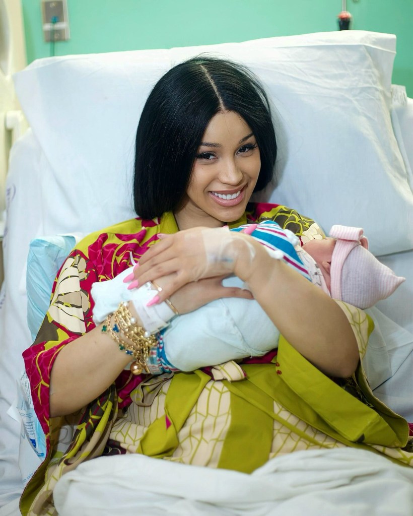 Card B holding her newborn