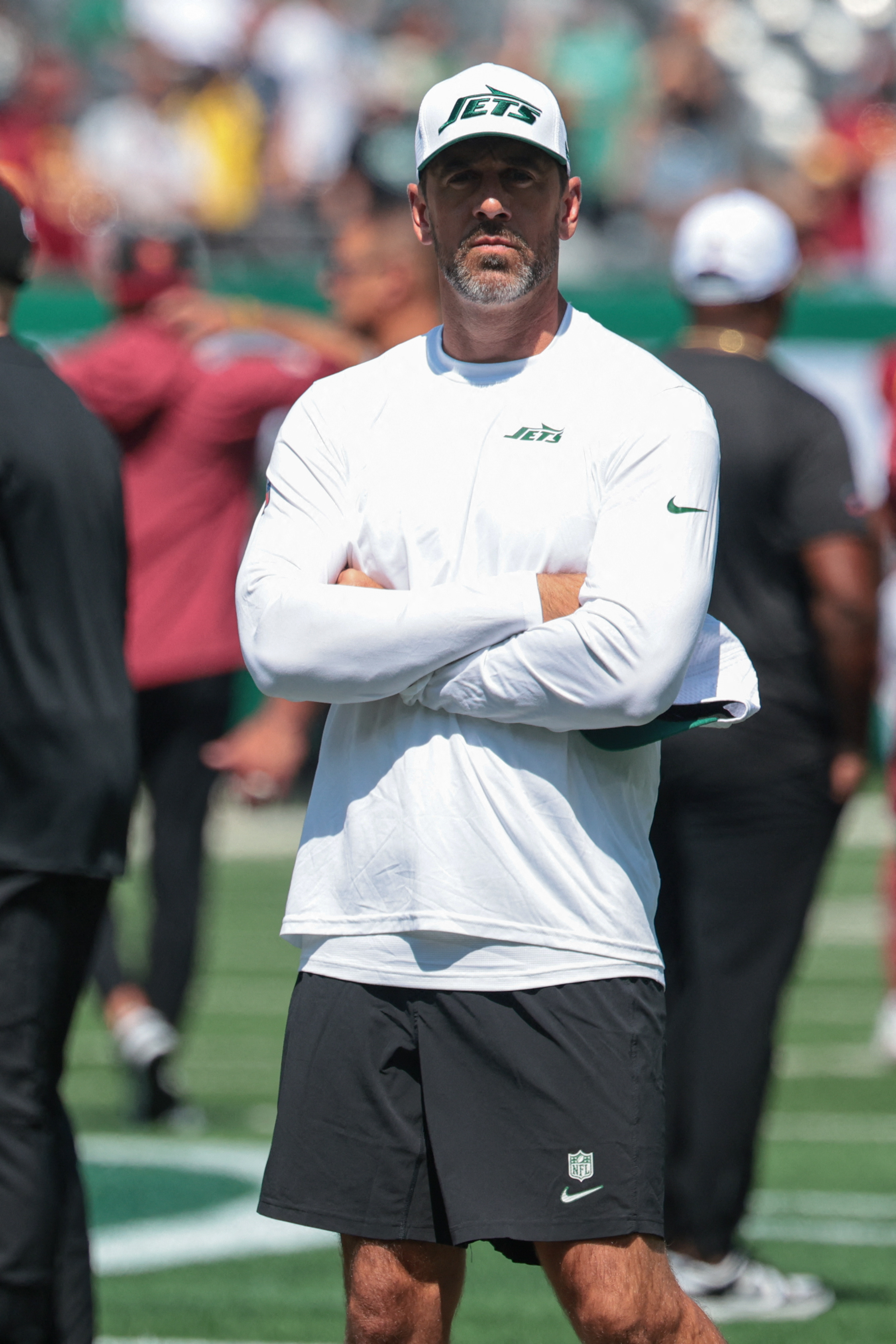 Aaron Rodgers standing at a Jets game