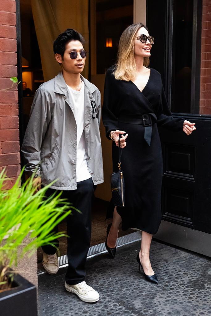 angelina jolie and pax jolie-pitt exiting a hotel