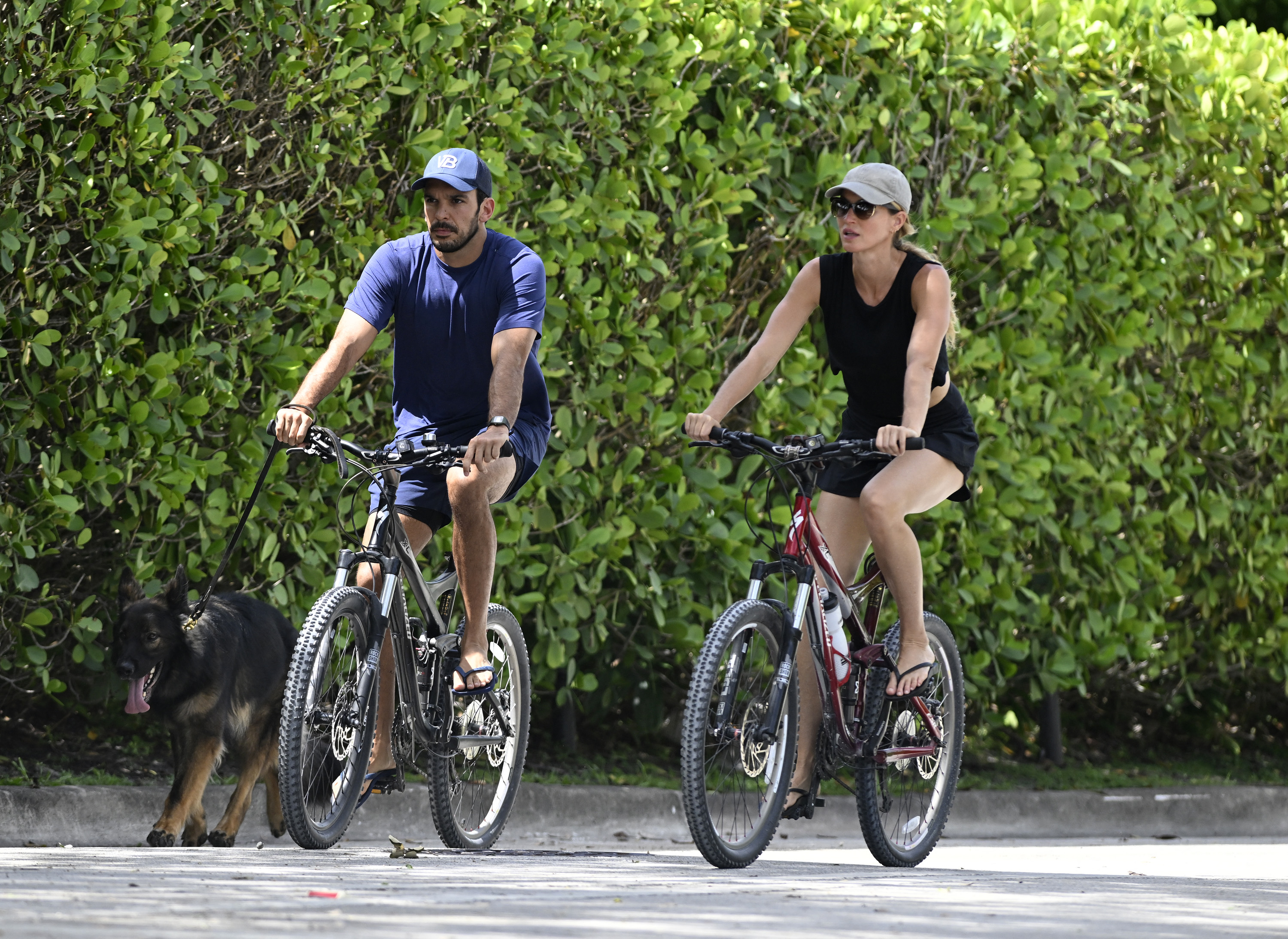 Gisele Bündchen and Joaquim Valente riding bikes together in July 2024.