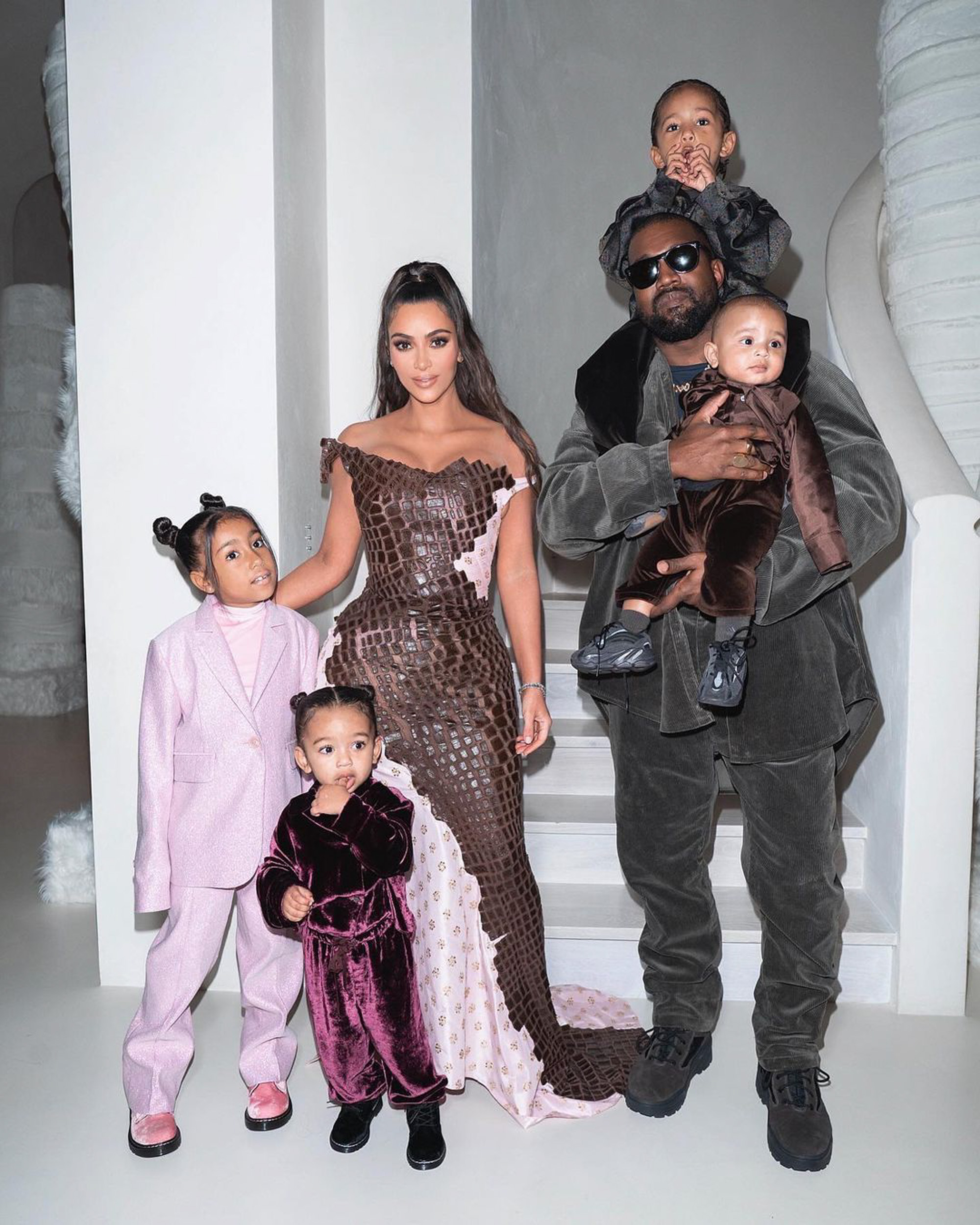 North West, Chicago West, Kim Kardashian, Kanye West, Saint West and Psalm West posing in front of a staircase