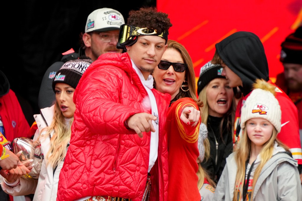 Patrick Mahomes and mother Randi Mahomes celebrate on stage during the Kansas City Chiefs Super Bowl LVII victory parade on Feb. 15, 2023 in Kansas City.