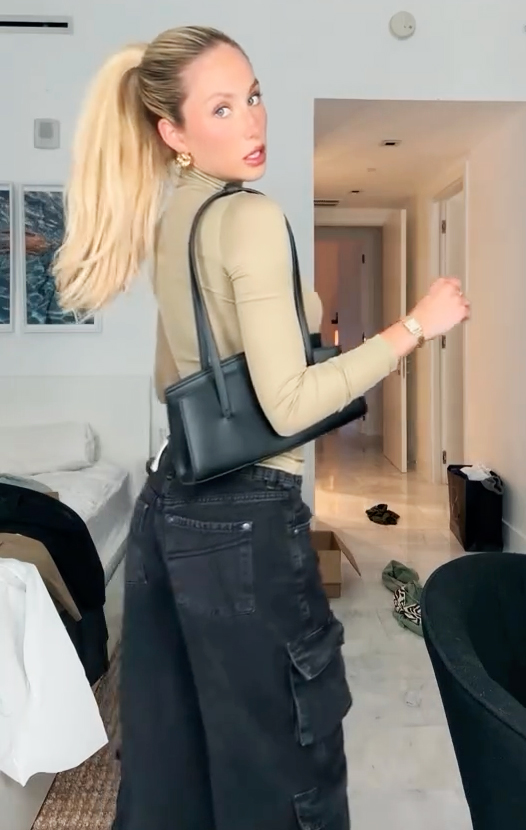 Alix Earle with a black purse