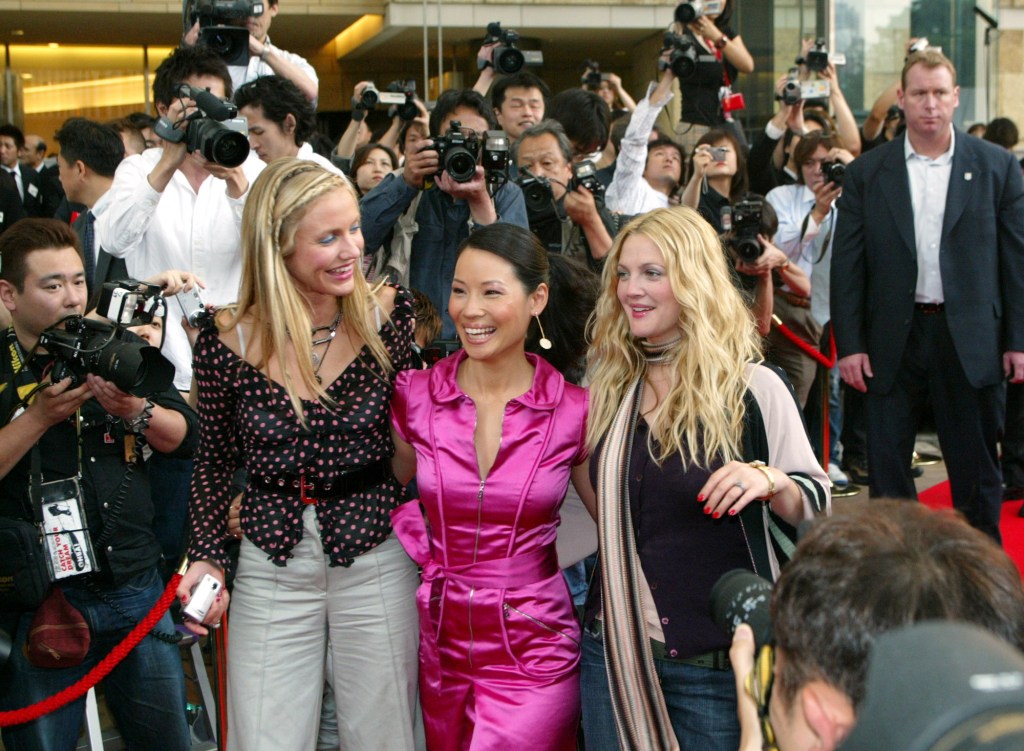 Charlie's Angels trio, from left, Cameron Diaz, Lucy Liu and Drew Barrymore, arrive at a press conference to promote their sequel "Charlie's Angels, Full Throttle"  in Tokyo in June 2003.