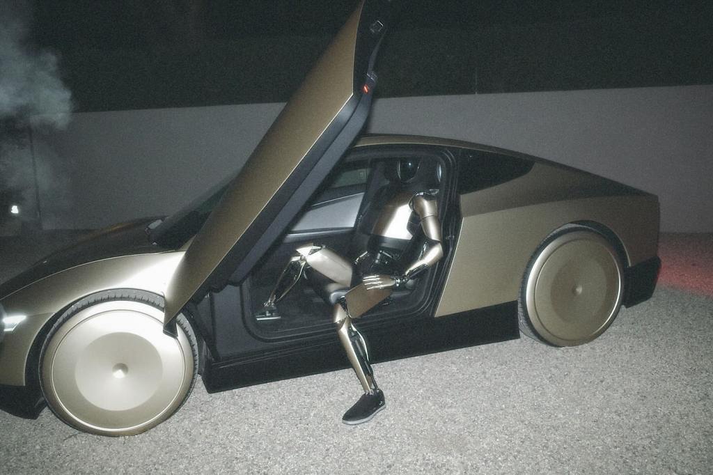 Kim Kardashian posing in a Balenciaga outfit with a Tesla robot with a gold Tesla Cybertruck in a photo posted to her Instagram on Nov. 19. 