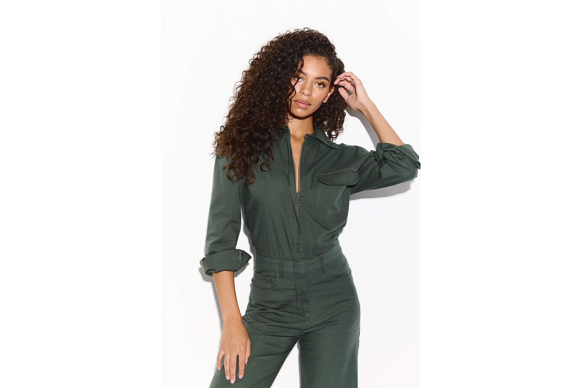 A model in a green jumpsuit