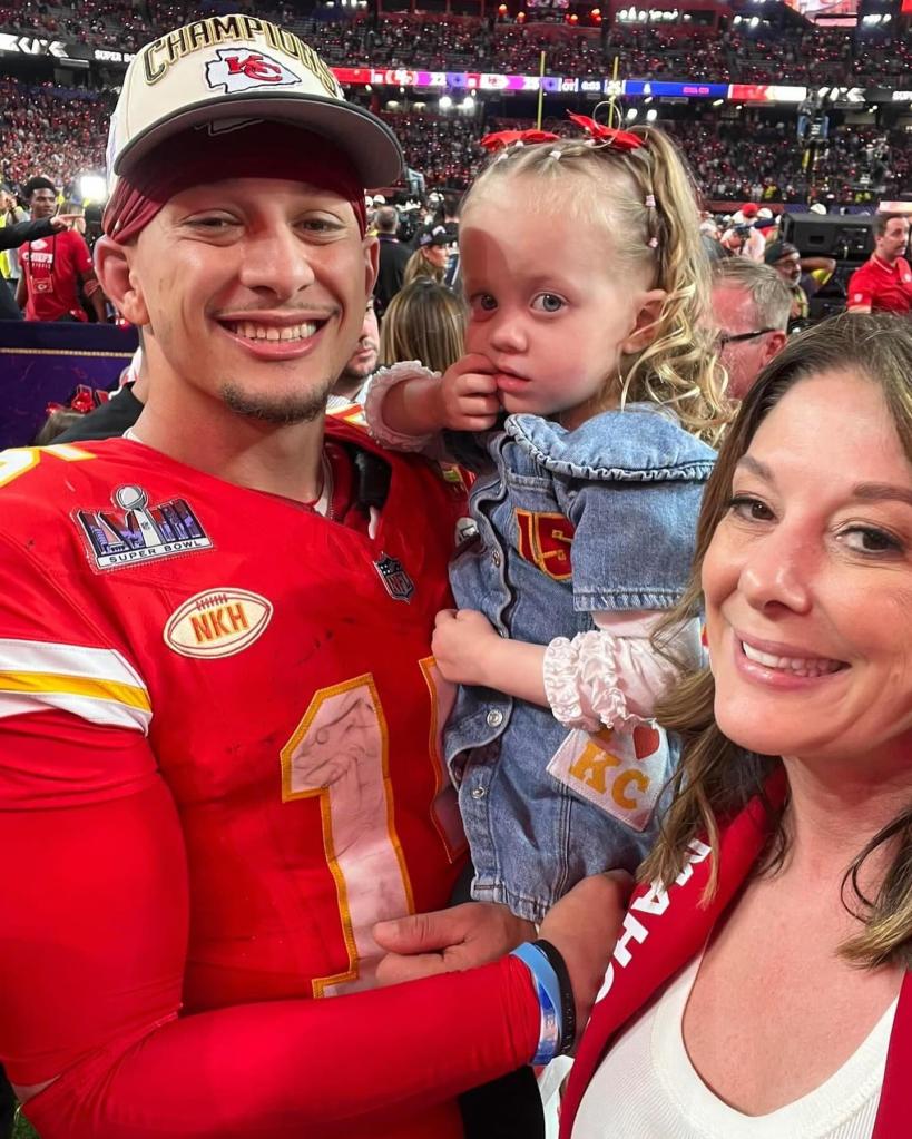 Patrick Mahomes and Randi Mahomes pose together at a Chiefs game.