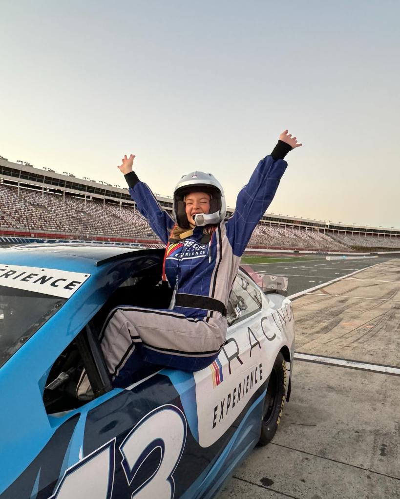 Sydney Sweeney is all suited up to go for a fast ride around a race track.