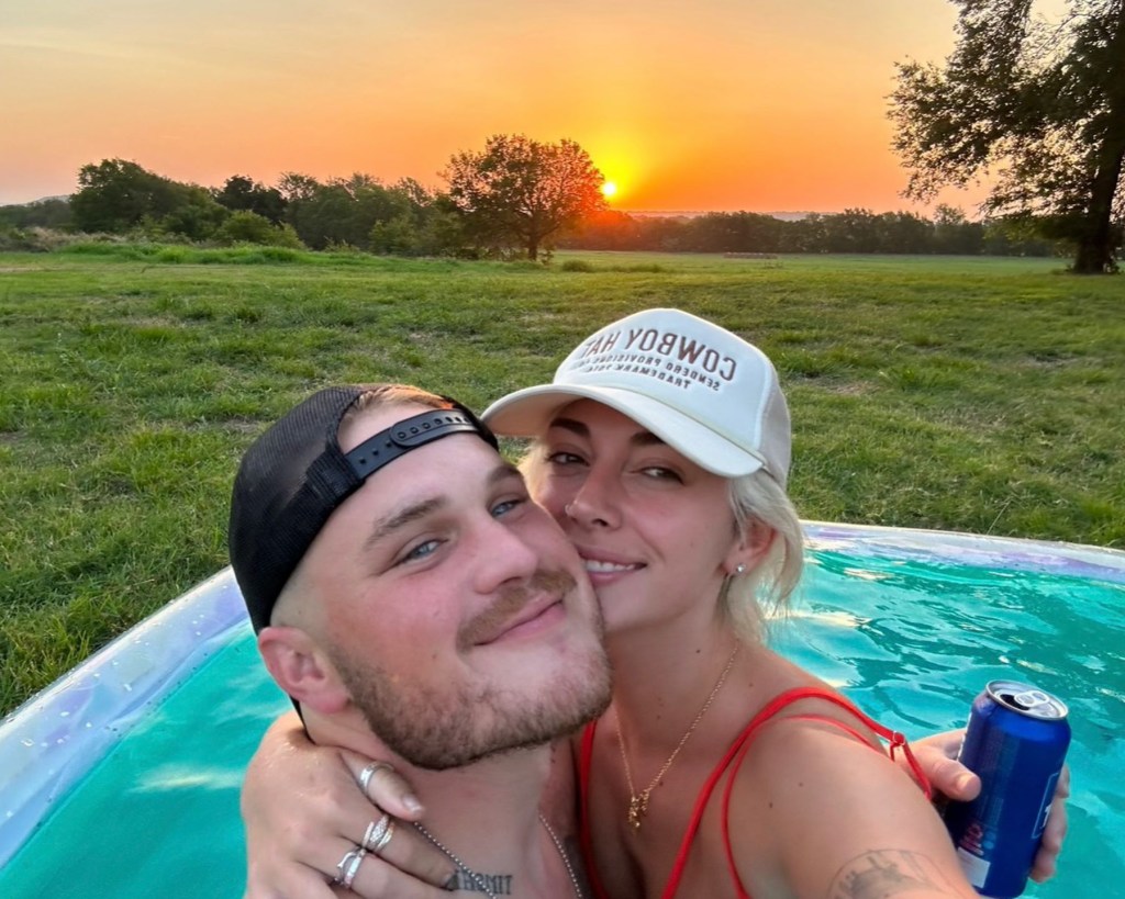 Zach Bryan and girlfriend Brianna Chickenfry pose together.