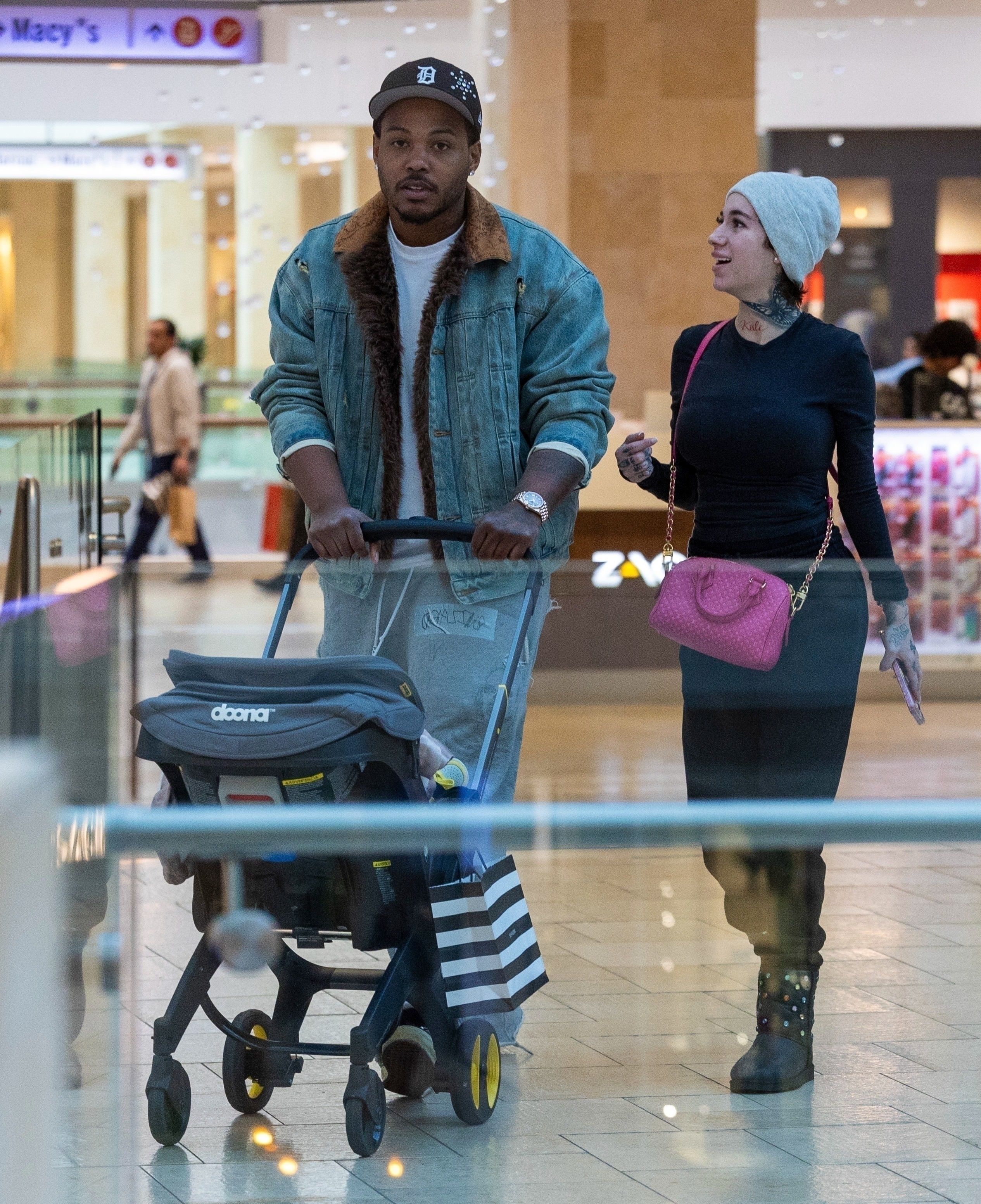 Le Vaughn and Bhad Bhabie shopping with their daughter.