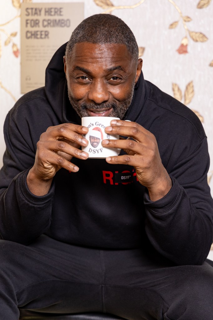 Idris Elba gets a mug with his face on it at the Don't Stop Your Future pop-up shop launch at The Truman Brewery in London.