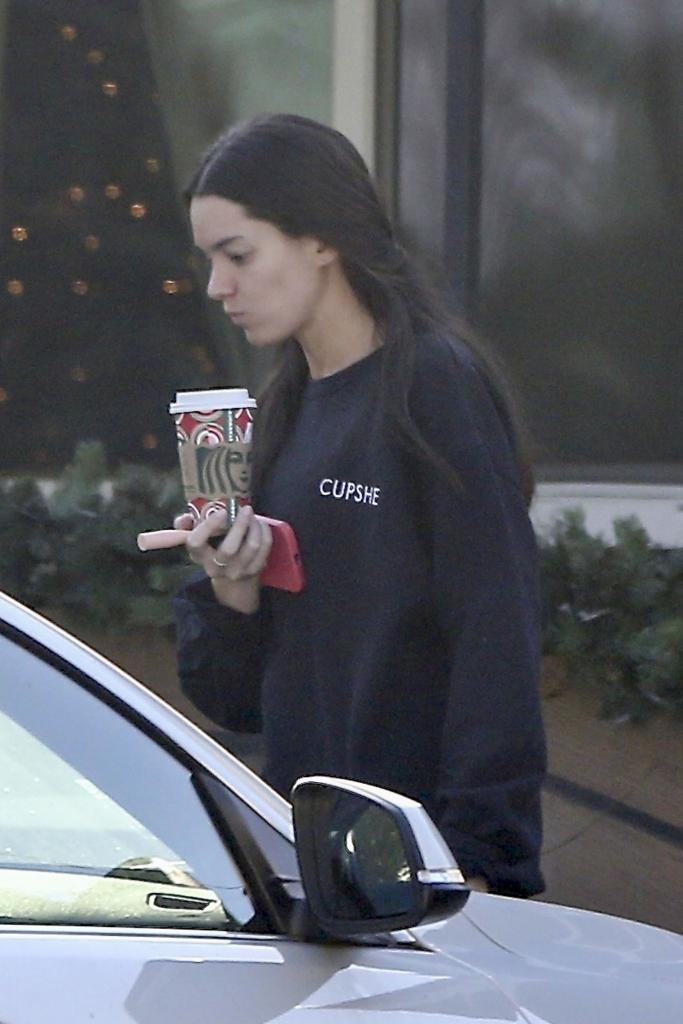 Ally Lewber carries a Starbucks cup